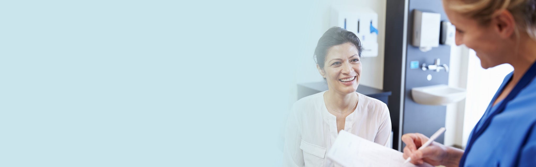 Couple walking on beach while holding hands of each other.